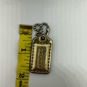 Coach metallic gold leather hangtag